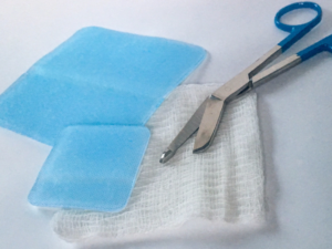 Hydrogel dressing sheets with gauze and scissors
